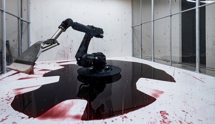 A robot sweeping up after itself, intended to show the overlap of automation and industry